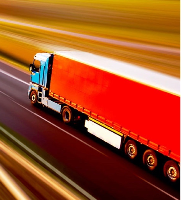 Red freight trunk driving on a highway 