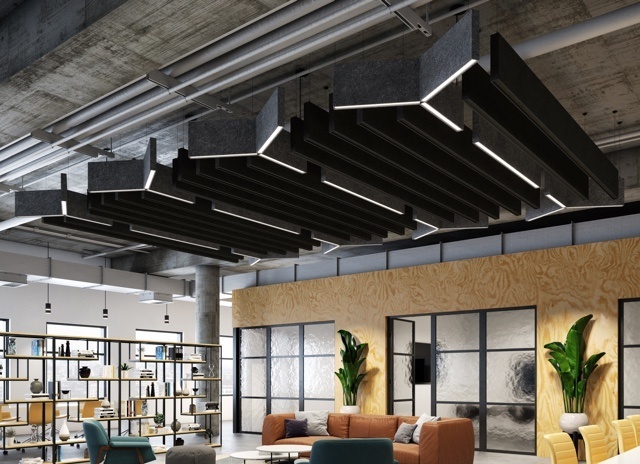 Open lounge space, with couches, plants and black ceiling lighting