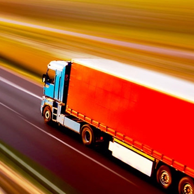 Red semi truck moving quickly 