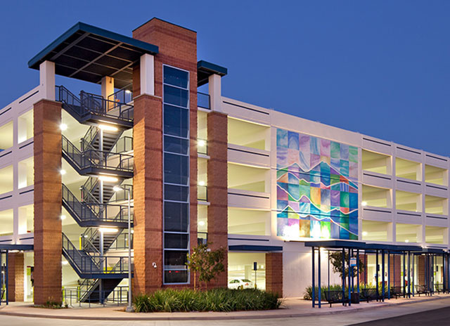 Lighting for parking garage with painting on one side